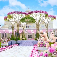 Our signature Lotus Vidhi Mandap creates a truly royal and unforgettable setting for your vows. We designed this magnificent structure to stand out against the palatial backdrop, using thousands of pink and white florals to craft an atmosphere of pure romance and grandeur.