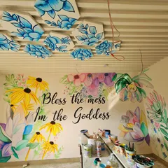 The finished art for a reception area, combining a colorful hand-painted floral mural with custom 3D hexagonal panels on the ceiling. The piece brings life and personality to the entire room.