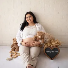 A fun and relaxed solo shot with props like teddy bears and a "Ready To Pop" sign, adding a touch of humor to the casual session.