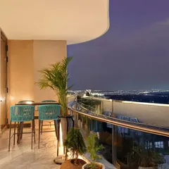This spacious balcony at The Amaryllis, New Delhi, was designed as a serene escape with a stunning city view. We created a comfortable and stylish outdoor seating area, perfect for evening relaxation, seamlessly extending the home's living space into the open air.