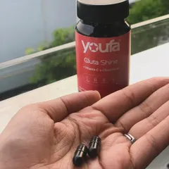 A close-up of the Youfa Gluta Shine capsules. These supplements, containing Vitamin C and Glutathione, have become a key part of my daily routine for achieving healthy, glowing skin from within.