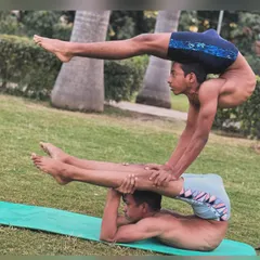 Test your strength with a partner. This two-person stack requires immense stability from the base and core control from the top person. We build up to this level with specific drills.