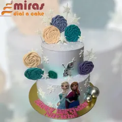 A magical two-tier cake for a Frozen fan, featuring edible images of Anna and Elsa, a fondant Olaf, and beautiful frosted rosettes. The delicate snowflakes and shimmering silver balls complete this winter wonderland creation.