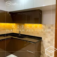 This kitchen uses a warm color palette with brown acrylic cabinets and a textured tile backsplash. The under-cabinet lighting provides excellent task lighting while highlighting the beautiful tiles.
