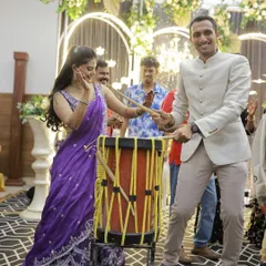 It's always fun to mix in live elements. Here, the guests are having a blast with a traditional drum during the sangeet, adding a unique and personal touch to the celebration.