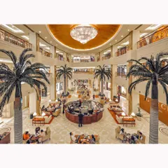 An interior view of the mall's grand atrium, showcasing its multi-level design, luxurious chandelier, and sophisticated ambiance. This image is designed to convey a high-end shopping experience.