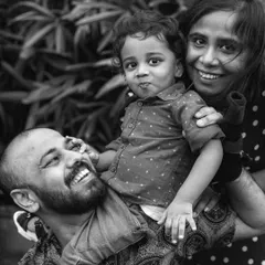 Sometimes, a moment feels so timeless it calls for black and white. This is the same joyful family portrait, edited to emphasize the raw emotion and connection, from the dad's laughter to the toddler's playful expression.