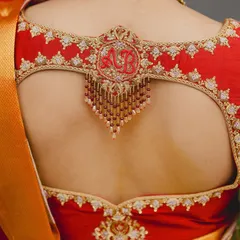For my bride Brunda, we embroidered her and her groom's initials 'A' and 'B' inside a beautiful motif on the back of her muhurtham blouse.