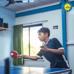 A young table tennis player in action during a match. I provide a space for juniors to develop their skills and passion for the game.