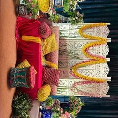 A complete view of our 'Mehendi Mhefil' setup. The vibrant seating with colorful cushions, a carved white screen, and beautiful floral arrangements creates a festive and comfortable space.