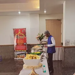 A member of my staff attending to the buffet line. You can see my company banner in the background, assuring you of our professional presence at your event.