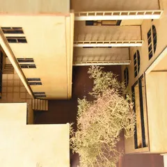 An overhead view of a sectional model reveals the intimate scale of a courtyard. This perspective allows us to study sightlines, a sense of enclosure, and the integration of landscape within the architectural form.