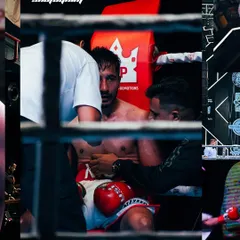 Some of the most critical moments happen between rounds. Shooting through the ropes, I capture the raw, unfiltered strategy sessions and the fighter's focus in the corner. This is the story behind the action.