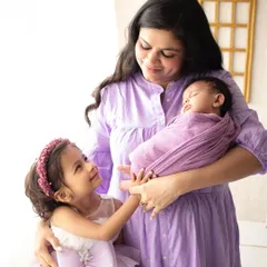 A big sister meets her new baby sibling. Capturing this first look of love and curiosity is such a special part of a newborn family session.