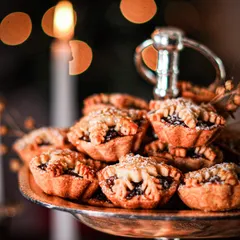 A tiered stand piled high with our classic Christmas mince pies. These sweet, spiced fruit-filled pastries are a holiday essential, best served warm with a dollop of our brandy butter.