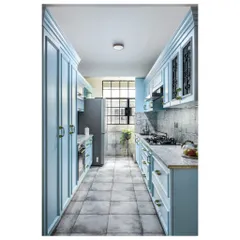For this galley kitchen, we chose a calming powder blue for the classic shaker-style cabinets. The look is clean, bright, and timeless. Details like the ornate handles and the patterned floor tiles add a touch of personality without overwhelming the narrow space, proving that even compact kitchens can be full of character.