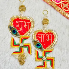 Welcome good vibes with this stunning Shubh Labh latkan featuring a heart shape and a swastika with a peacock feather.