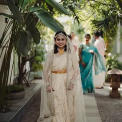 A beautiful bride walking down a stone pathway towards her wedding ceremony, embodying grace and anticipation. I ensure every entrance is as memorable as the vows themselves.