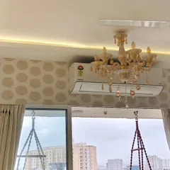 This image shows my skill in working around obstacles. The wallpaper pattern is perfectly continuous above and below the air conditioning unit, with no awkward cuts.