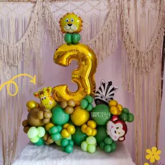 A fun and wild jungle-themed balloon bouquet for a 3rd birthday. It features a large number '3' foil balloon and adorable animal characters like a lion, giraffe, and monkey.