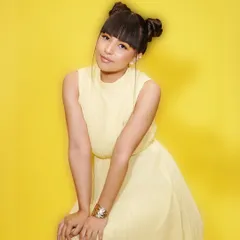 A full-length shot from our creative summer campaign. The bright yellow dress is paired with fun space buns and colorful makeup, demonstrating a playful and modern approach to beauty.
