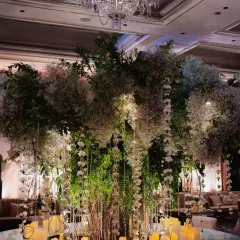 We brought the outdoors in for this stunning reception, centered around an iconic floral tree. Draped in baby's breath and crystal hangings, and surrounded by hundreds of candles, this installation transformed the ballroom into an enchanted forest.