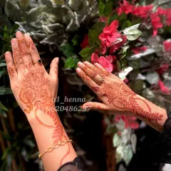 The beautiful, mature stain of my organic henna, pictured against a floral background. This shows the reddish-brown tones that develop after a day or two.
