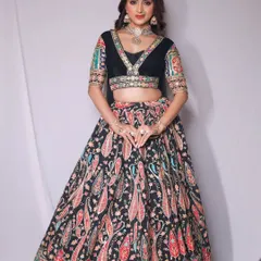 For a bold and stylish look, I suggest this black lehenga with a vibrant, multi-colored paisley print. The velvet blouse adds a touch of luxury, making it perfect for an evening sangeet or cocktail party.