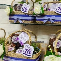 A closer look at the 70th birthday hamper, showing the custom "Cheers to 70" tag and the mix of edible and keepsake items.