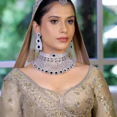 A beautiful portrait of the ivory bridal look. The makeup is soft and luminous, perfectly complementing the diamond and sapphire choker.