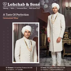 A taste of perfection in ceremonial wear. This classic off-white sherwani features subtle, all-over embroidery and is accessorized with a traditional safa and a multi-strand pearl mala, creating a look of understated elegance for the groom.