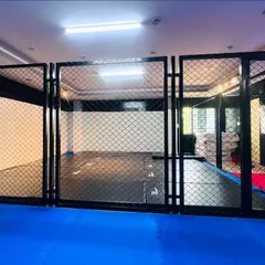 A direct look into the MMA fighting cage at our HSR facility. This professional setup is essential for realistic sparring and preparing fighters for competition scenarios.