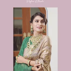 This portrait highlights the stunning details of the bridal jewelry, including the intricate nath (nose ring) and the layered necklaces. We ensure every piece works together to enhance the bride's natural beauty.