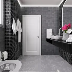 This view shows the floating vanity and sleek black countertop, contrasting with the white door in this contemporary bathroom.