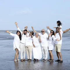 We specialize in capturing the entire 'khandaan'. This outdoor beach session shows a multi-generational family portrait, ensuring that grandparents, parents, and children all share in a beautiful, coordinated memory.