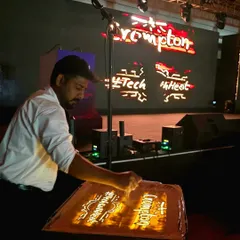 Here I am, live on stage, performing for a major corporate event hosted by Crompton. The art comes to life on the lightbox and is projected onto a large screen, ensuring every person in the audience experiences the magic.