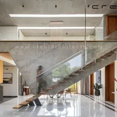We treat functional elements as sculptural art. This unique staircase in The Quarry House is cantilevered from a suspended concrete wall, creating a gravity-defying centerpiece that is both a passage and a statement of structural innovation.