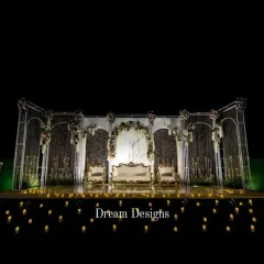 For the reception, I love creating a dramatic "wow" moment. This magnificent stage combines architectural arches, shimmering crystal curtains, and a candlelit mirrored floor to produce a truly unforgettable, high-impact setting for the evening's celebration.