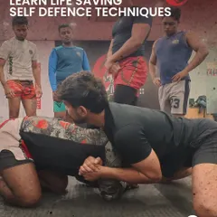 An instructor demonstrates a ground control position while other students observe. Our classes emphasize learning life-saving self-defense techniques through clear, step-by-step instruction.