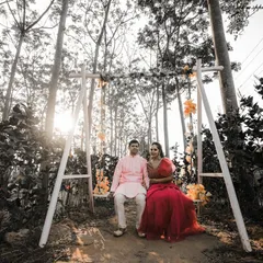 This serene pre-wedding portrait was taken in a beautiful wooded area. The swing and the soft sunlight create a dreamy, fairytale-like atmosphere for the couple's photo.