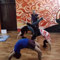 This is a glimpse from one of our evening yoga sessions. I am observing my students as they practice different variations of Chakrasana (Wheel Pose), ensuring everyone is supported. My goal is to create a space where everyone can challenge themselves safely.