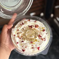 My XXL Rose Tres Leches tub cake, generously topped with whipped cream, dried rose petals, and pistachios. It's perfect for sharing.