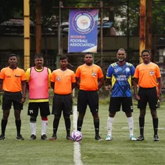 Our team captain stands with the official referees before a league match. We participate in professionally organized games, ensuring a true competitive football experience.