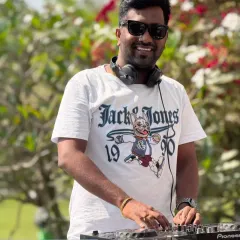 A candid shot of me DJing an outdoor event. You can see my Pioneer DJ controller, the heart of my setup.