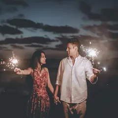 A quiet moment between the couple, illuminated only by the sparklers they hold. This kind of low light photography creates a very intimate and romantic mood.