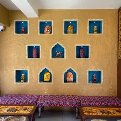 For this project, I brought a traditional Indian vibe to a modern eatery. The textured mud wall is highlighted by hand-painted niches, each telling a small story and creating a warm, inviting atmosphere for guests.