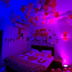 In this birthday setup, I spelled out 'I LOVE YOU' with rose petals on the bed, adding an extra layer of romance to the celebration. The 'Happy Birthday' foil balloons are visible above the bed.