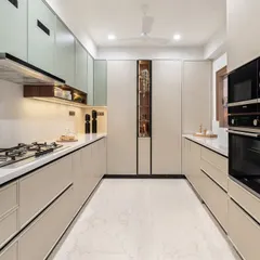 This sleek, modular kitchen is designed for ultimate functionality. The parallel counters provide ample workspace, while the subtle two-tone cabinets and integrated appliances create a clean, modern aesthetic.