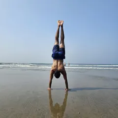 Finding my balance on the beach in Goa. The unstable surface of the sand adds an extra challenge to holding a handstand.