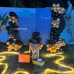 A luxury-brand inspired birthday setup with a black and gold theme for a high-fashion vibe.